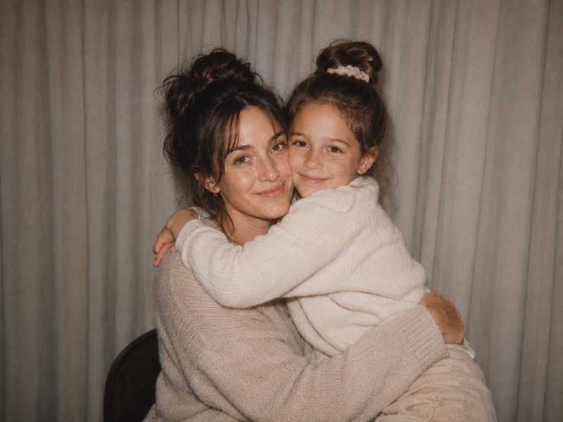 An adult holding their younger self.