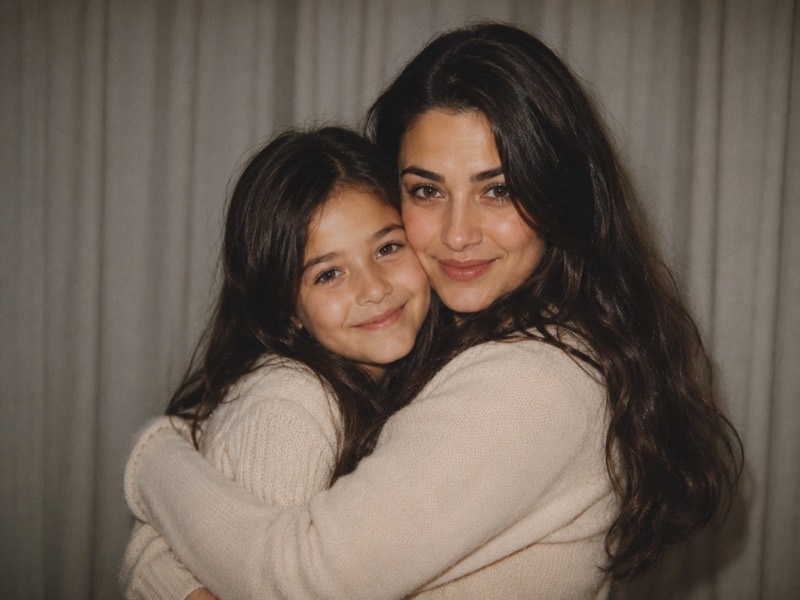 An adult holding their younger self.