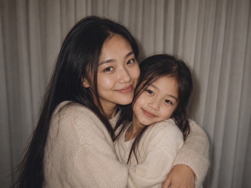 An adult holding their younger self.